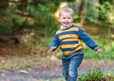 a young boy runs around in his isle of lewis family portrait session
