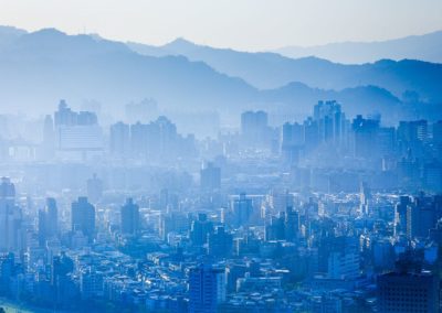 buildings are shown in the shaows of fog over the skyline of taipei